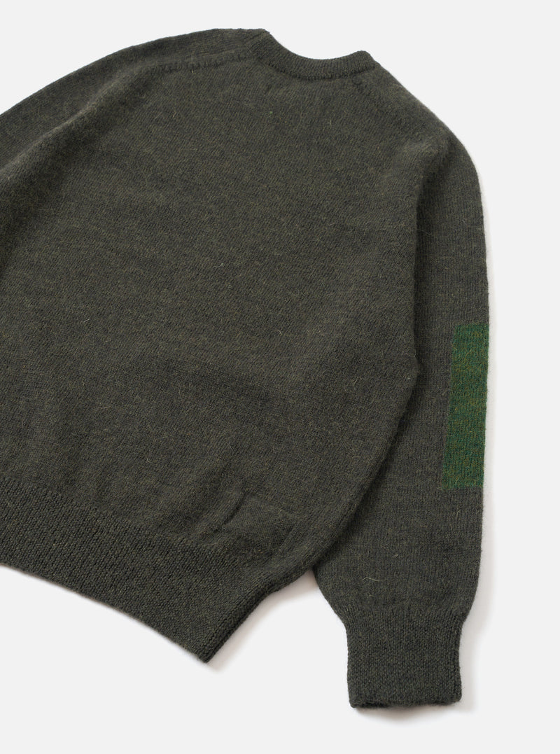 Back view of the Olive British Wool Lyon Crew sweater displayed on a plain white studio background. Highlights the comfortable regular fit, raglan sleeve construction, and textured marled olive green British wool fabric.