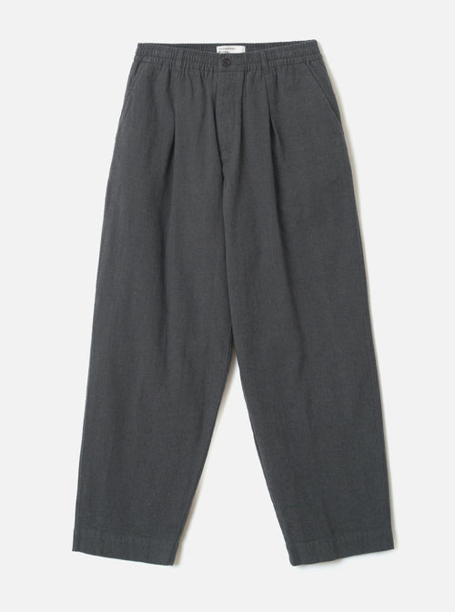 A front view of the Grey Liverpool Check Oxford Pant laid out flat against a plain white background. The loose-fit trousers feature a drawstring waistband, front pleats, side pockets, and a subtle grey cotton-linen check weave.