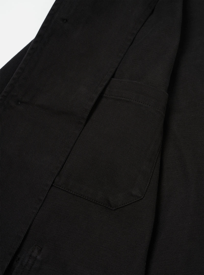 Interior detail view of the Black Dexter Twill OG Bakers Chore Jacket set against a neutral white backdrop. The image showcases the inside hip pocket, interior chest pocket, shoulder lining, and fine seam construction.