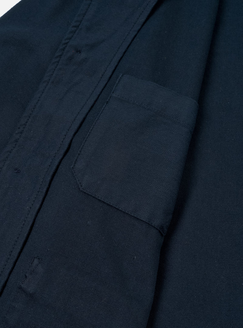 A close-up detail shot of the Navy Slub Sateen Ives Jacket against an off-white background, highlighting the collar structure, contrast buttons, front chest patch pocket, and slub sateen cotton fabric weave.