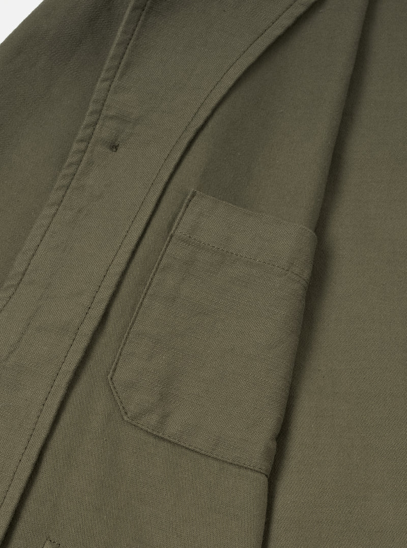 Detailed close-up view of the Olive Slub Sateen Ives Jacket on a neutral studio background, focusing on the spread collar, dark front buttons, topstitching, and upper front patch pocket details.