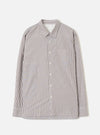 Brown and white vertical stripe cotton shirt, flat lay on a light grey backdrop. Point collar, front button placket with cream buttons, chest patch pocket, two large lower patch pockets, and button cuffs. Universal Works label visible at neck.