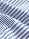 Close-up detail of the navy and white Bengal stripe cotton fabric on the Queens patched shirt. The shot highlights the woven texture and a neat seam joining two panels, with fine topstitching visible along the edge.