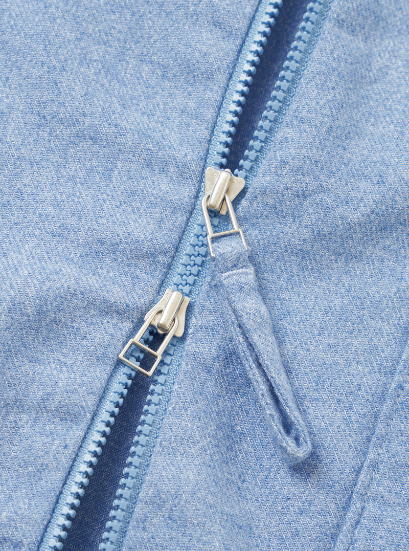A close-up detail shot of the Sky Blue Monty Cotton Tencel Zip Shirt set against a plain white background, highlighting the front zipper hardware, collar structure, and fabric texture.