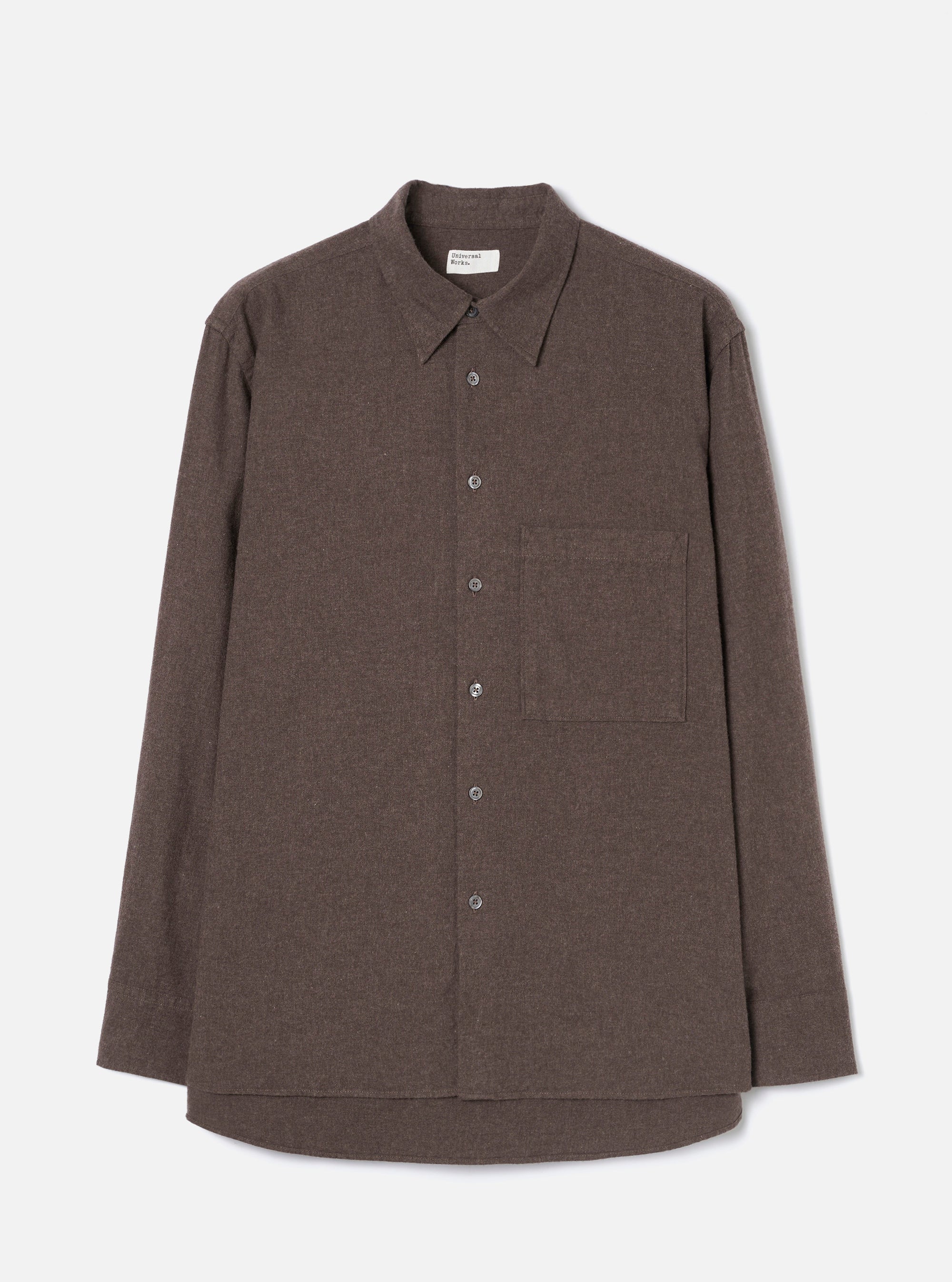 Brown brushed flannel shirt on a plain light grey studio backdrop, no model or mannequin. Features a point collar, five-button placket with dark buttons, one large patch pocket on the left chest, long sleeves with plain cuffs, and a curved hem. The fabric has a soft, matte flannel texture in a muted brown marl.