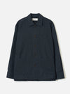 Navy flannel overshirt in a fine stripe texture, laid flat on a white studio backdrop. Features a spread collar with a Universal Works woven label, five dark buttons down the centre front, two large patch pockets at the hip, and wide cuffed sleeves.