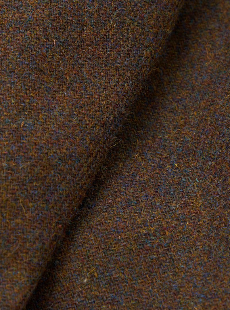 A close-up macro shot of the Brown Harris Tweed Easy Jacket fabric swatch. The image fills the frame to show the intricate woven detail, rich brown wool threads, and fine material texture.