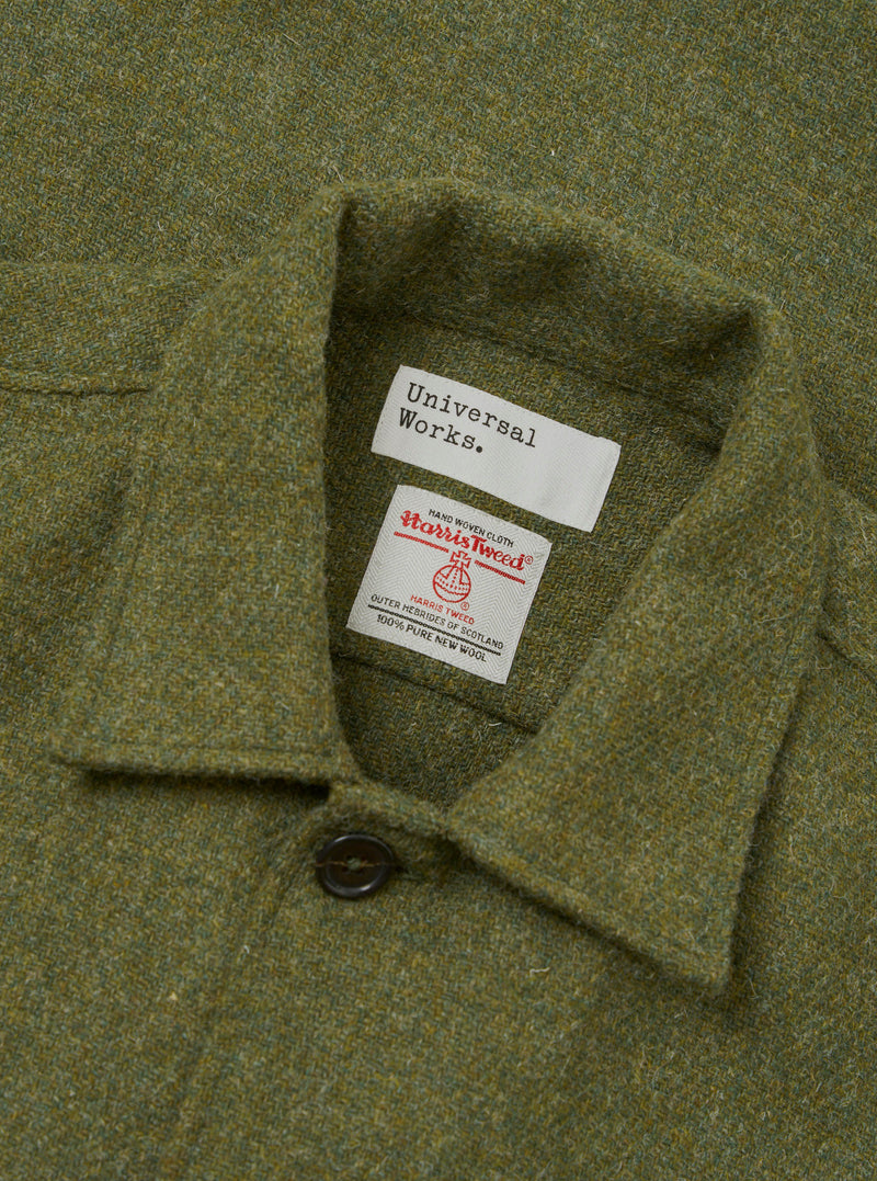 An angled detail view of the Olive Harris Tweed Easy Jacket against a neutral white backdrop. The photo brings focus to the lapels, woven fabric texture, and neatly finished front buttons.