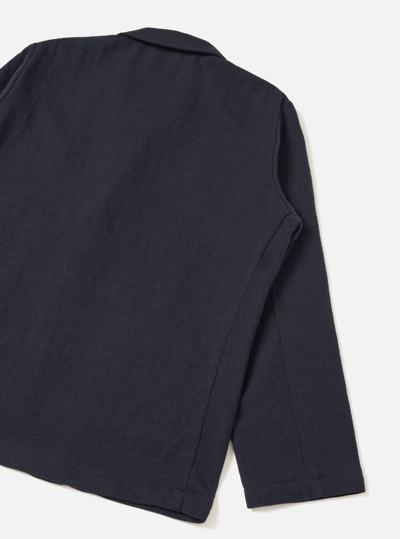 A detailed back view of the Dark Navy Robin Wool Mix Two Button Jacket presented against a plain off-white studio background, highlighting the clean rear hem, subtle shoulder construction, and textured wool-blend fabric.