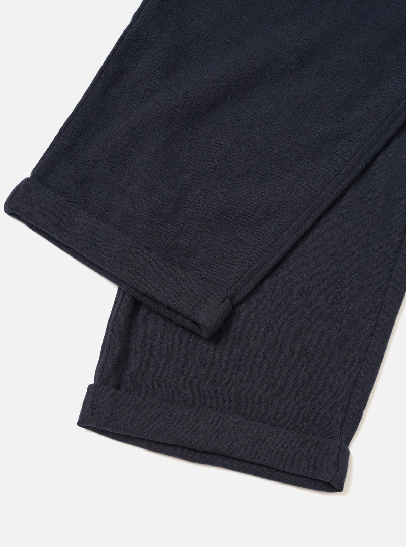 A male model wears the Dark Navy Robin Wool Mix Lindberg Pant in an angled pose against a white studio background, illustrating how the trousers drape and fit around the waist and legs.
