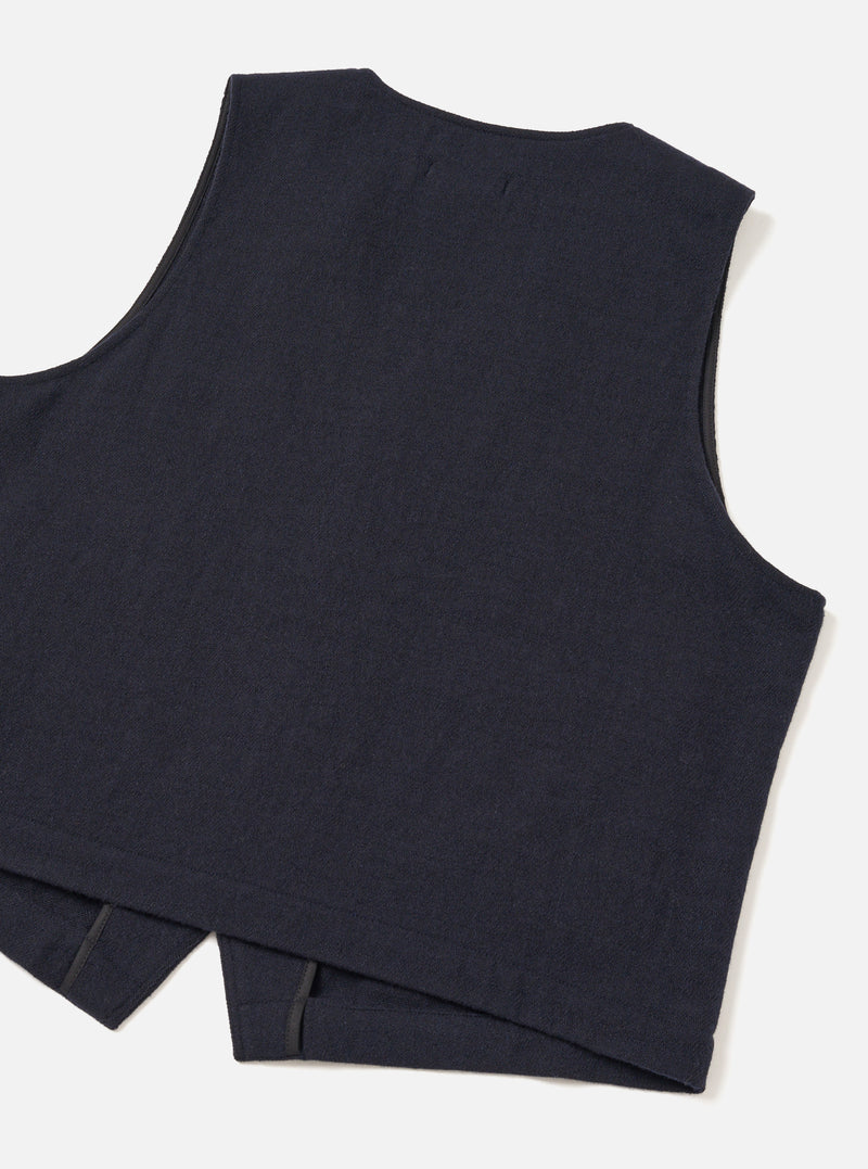 Back view of the Dark Navy Robin Wool Mix JJ Waistcoat set against a clean studio background, showing the unlined back panel made from the same dark navy wool-blend fabric and clean hemline.