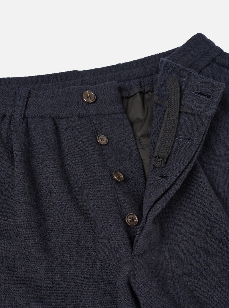 A detailed close-up shot of the Dark Navy Robin Wool Mix Pleated Track Pant waistband on a plain background, highlighting the front single pleat, drawstring closure, and fine fabric texture.