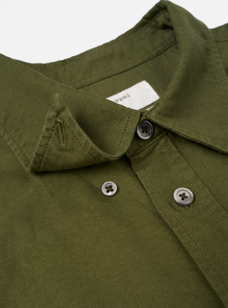 A full-length shot of a male model wearing the Olive R.Oxford Lazy Day Shirt paired with casual trousers against a studio background, illustrating the versatile smart-casual aesthetic.