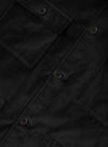 Close-up detail of the Black CPH Velvet Dockside, showing the button placket with four-hole dark buttons and a chest patch pocket with a buttoned flap. The fabric has a rich velvet texture with a soft, matte finish. No model or mannequin visible.