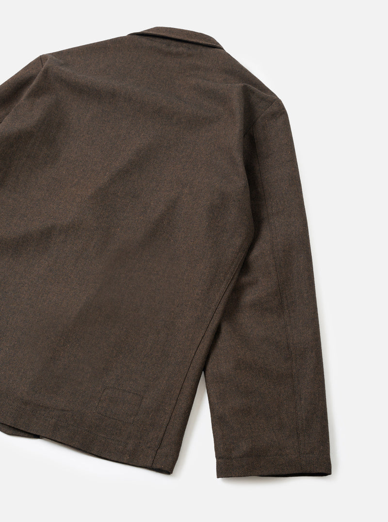 A back view of the Brown Recycled Italian Tweed Two Button Jacket set against a clean, neutral studio background. The shot highlights the structured shoulders, smooth rear panel, and neat hem finish of the tailored brown garment.