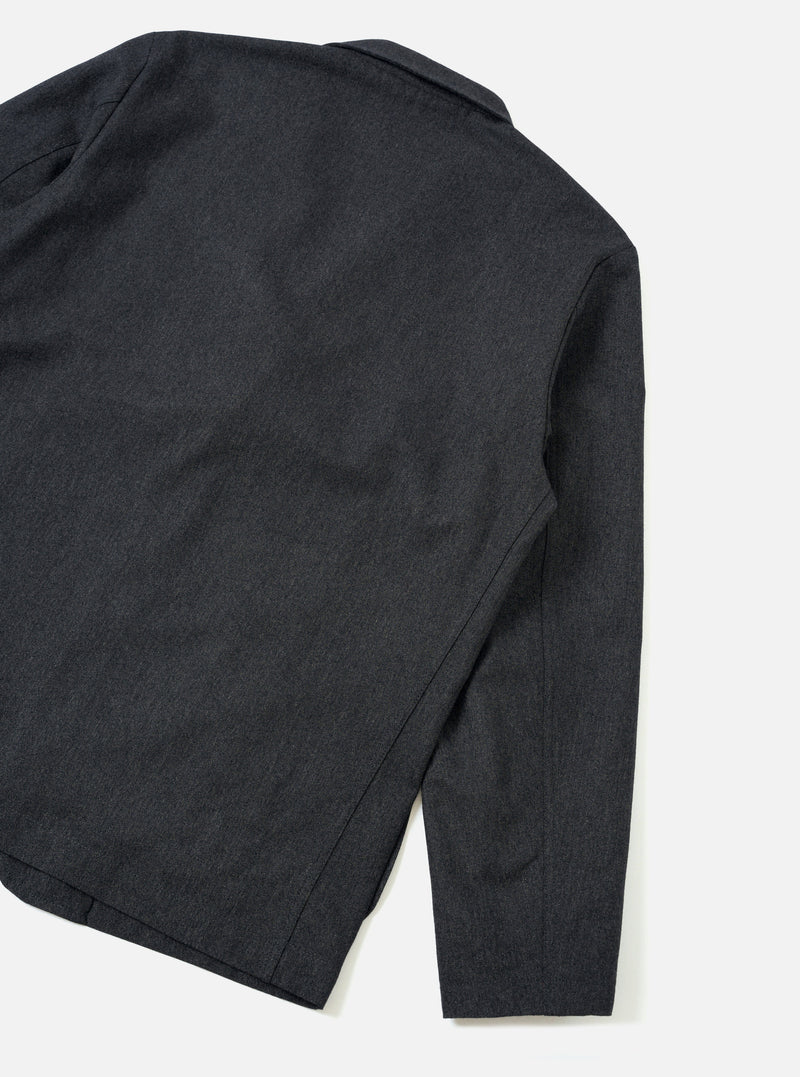 A back view of the Charcoal Recycled Italian Tweed Two Button Jacket set against a plain off-white background. The shot showcases the tailored rear panel, clean shoulder line, and dark charcoal tweed fabric construction.