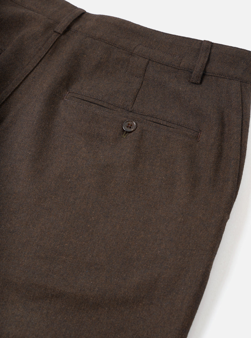 A close-up view of a model wearing the Brown Recycled Italian Tweed Military Chino, focusing on the waistband, belt loops, and side entry pocket. The detailed shot highlights the rich brown tweed fabric against a studio background.