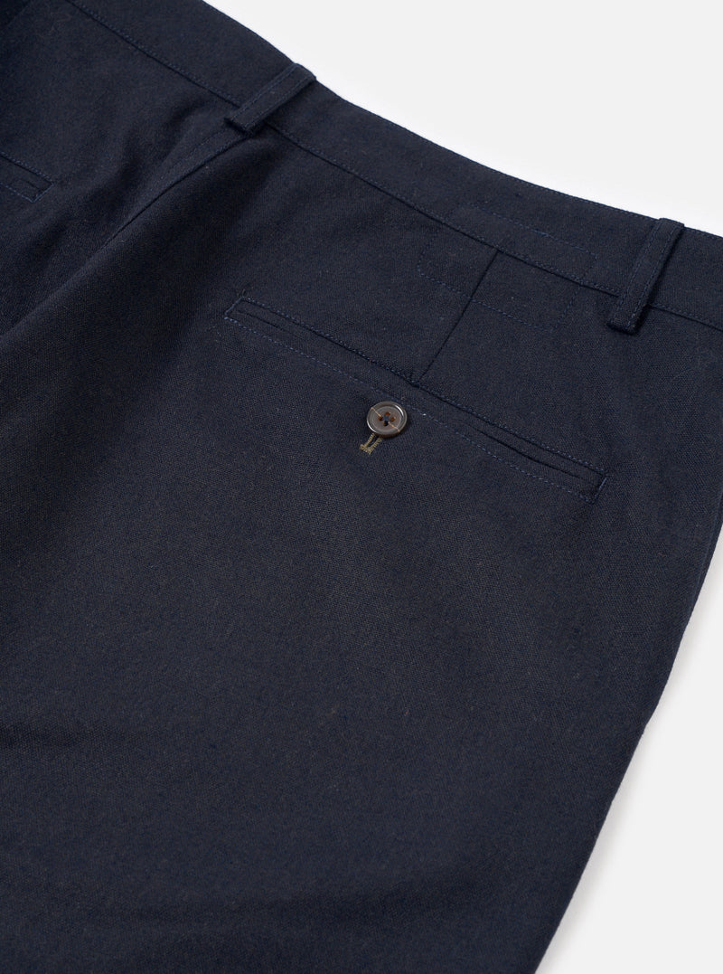 A close-up view of a model wearing the Navy Recycled Italian Tweed Military Chino, focusing on the waistband, button closure, and side pocket detail. The shot highlights the rich navy tweed texture in a studio setting.