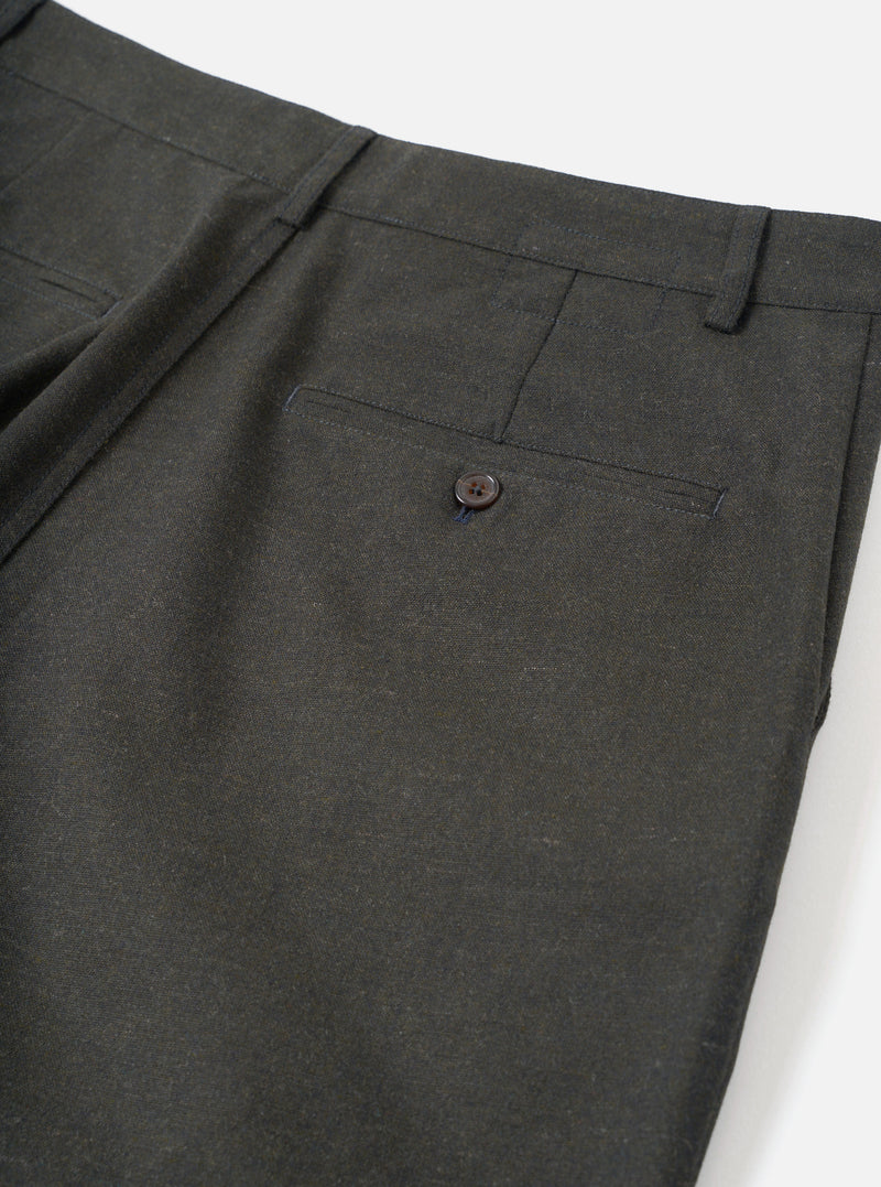 A close-up view of a model wearing the Olive Recycled Italian Tweed Military Chino, focusing on the side pocket, waistband, and belt loops. The image highlights the detailed olive green tweed texture in a studio.