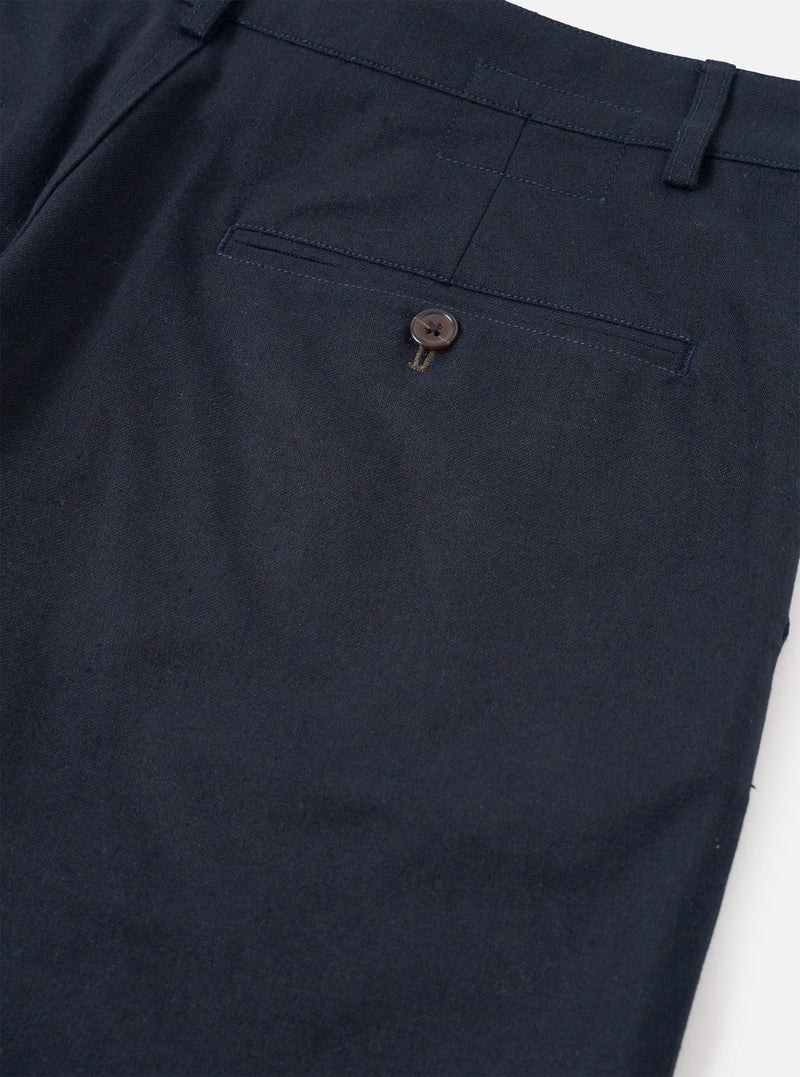 A close-up photograph of a model wearing the Navy Lucca Suiting Military Chino, emphasizing the waist, belt loops, side pocket details, and dark navy fabric texture against a neutral background.