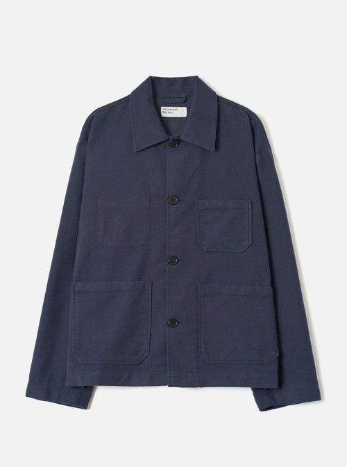 A full-length front view of a model wearing the Navy Comfort Moleskin Ives Jacket against a neutral studio backdrop, showcasing the button front, utility patch pockets, and rich navy blue moleskin fabric.