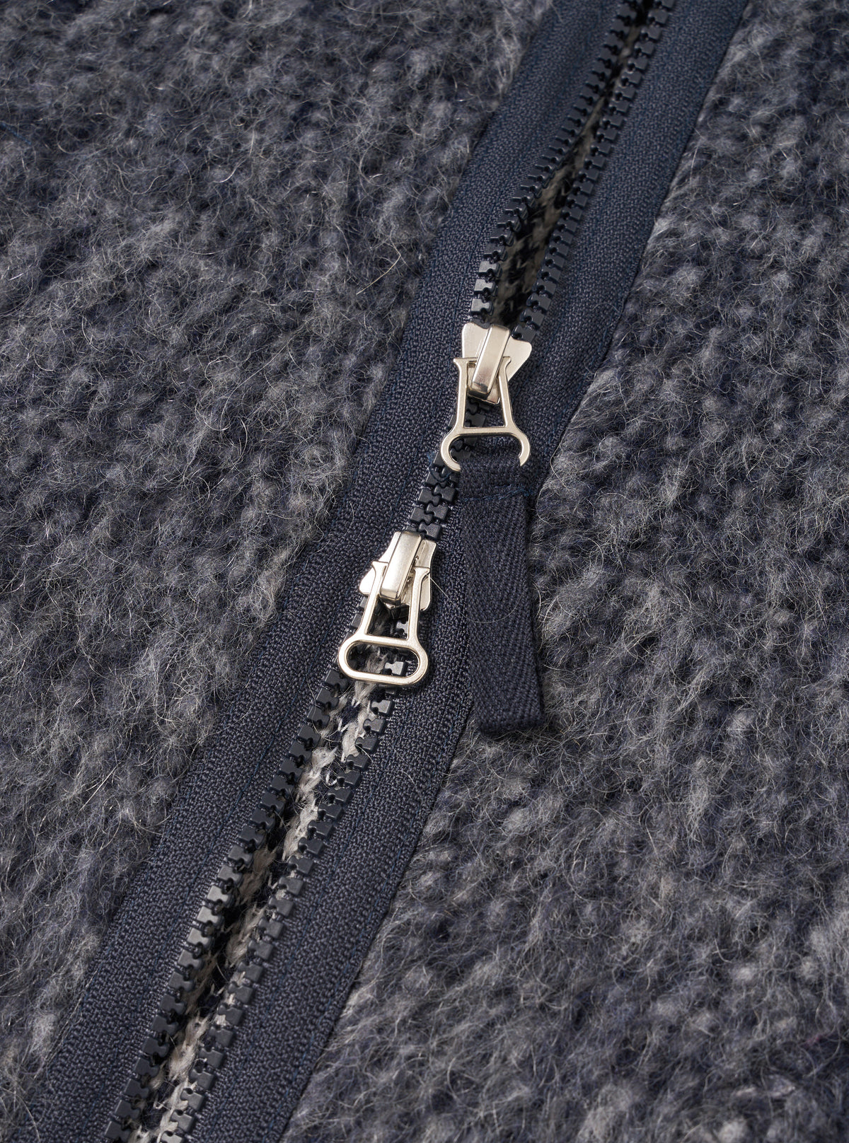 A close-up detail shot of a model wearing the Navy/Pale Grey Losso Mohair Mix Zip Liner Jacket, showing the zipper, neckline, and fuzzy texture of the navy and pale grey mohair blend fabric.