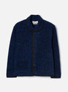 Blue boucle style fleece Lancaster jacket laid flat on a light grey seamless backdrop. The jacket features a shawl collar, five dark buttons down the centre front, and a patch pocket at the lower left. Black binding trims the collar, front placket, cuffs, and hem. A Universal Works branded label is visible at the inner collar.