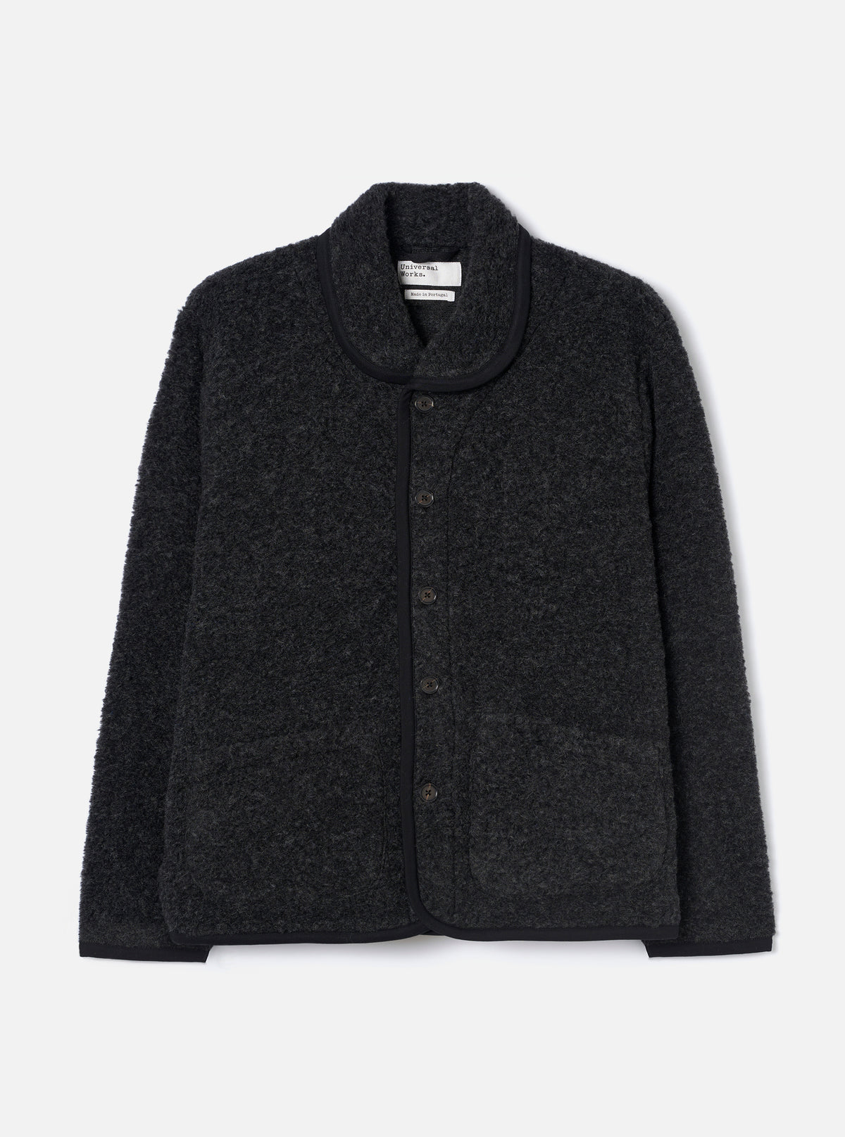Charcoal boucle style fleece Lancaster jacket laid flat on a light grey studio backdrop. Features a shawl collar with black trim, five-button front placket, two large patch pockets, and a ribbed hem. The textured boucle style fabric has a looped, marl appearance throughout.