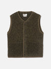Brown boucle style fleece gilet laid flat on a light grey studio backdrop. V-neckline with brown binding trim running around the neck, armholes and hem. Six dark buttons fasten the centre front placket. Universal Works woven label visible at the neck. Textured, looped fleece fabric throughout.