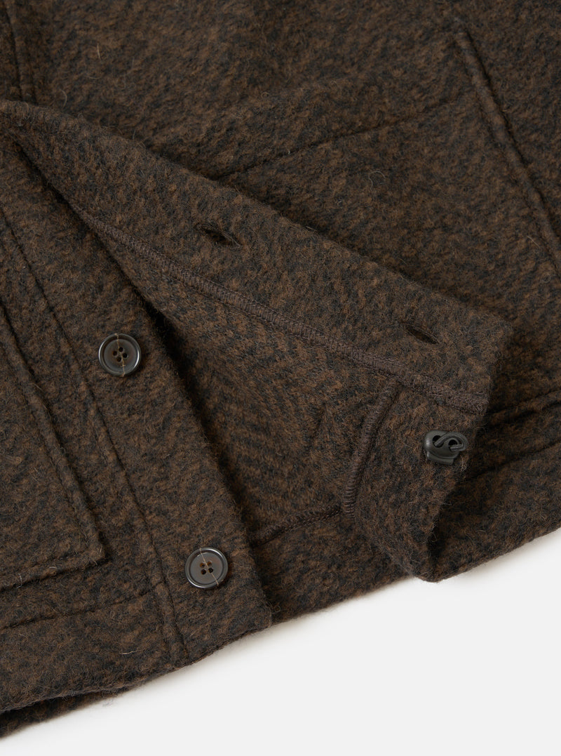 A detailed close-up shot of the Brown Raven Fleece Advance Cardigan against a white background, highlighting the front button placket, fine hem stitching, and soft, fuzzy texture of the brown wool fleece.