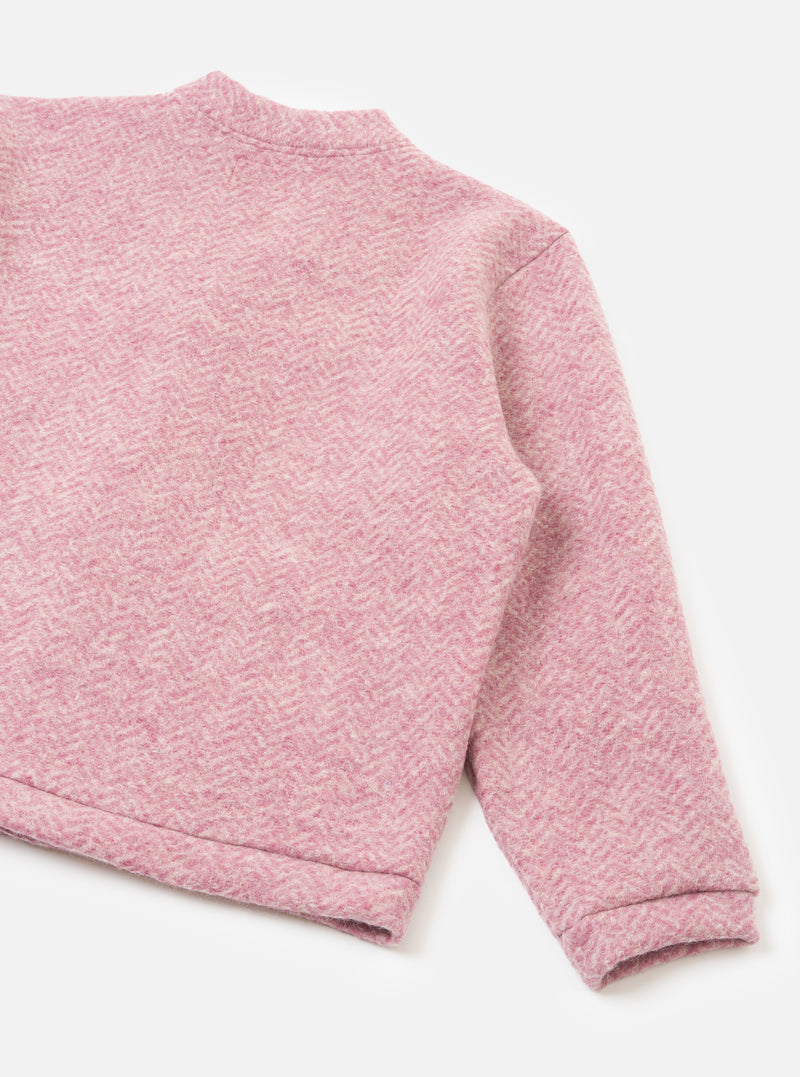 A back view photograph of the Pink Raven Fleece Advance Cardigan on a plain white studio background, showing the rear seam structure, soft fleece finish, and rich pink tone of the cardigan knit.