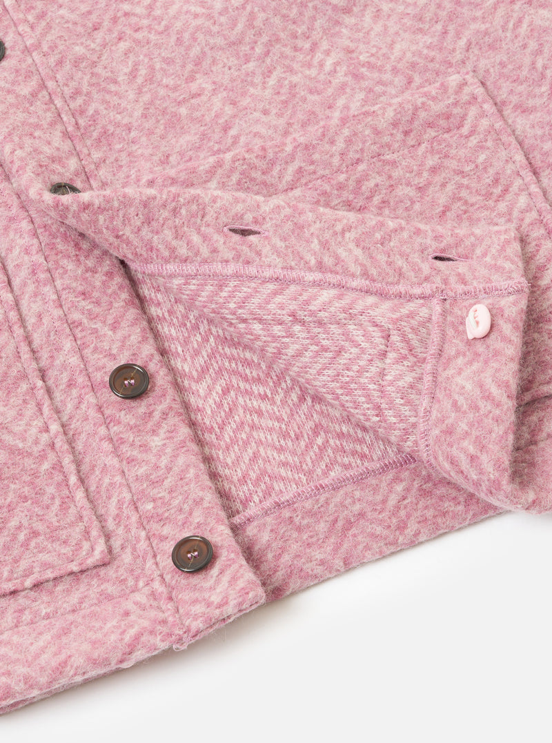 A detailed close-up shot of the Pink Raven Fleece Advance Cardigan against a white background, showcasing the front buttons, pocket trim, and fuzzy surface texture of the pink raven fleece fabric.