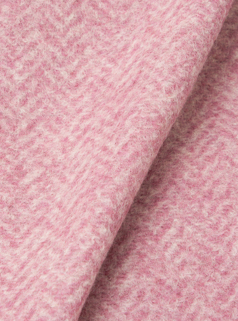 A detailed fabric swatch shot of the Pink Raven Fleece Advance Cardigan on a white background, featuring the high-textured wool fleece pile and distinctive pink color variations in the knitted fabric.