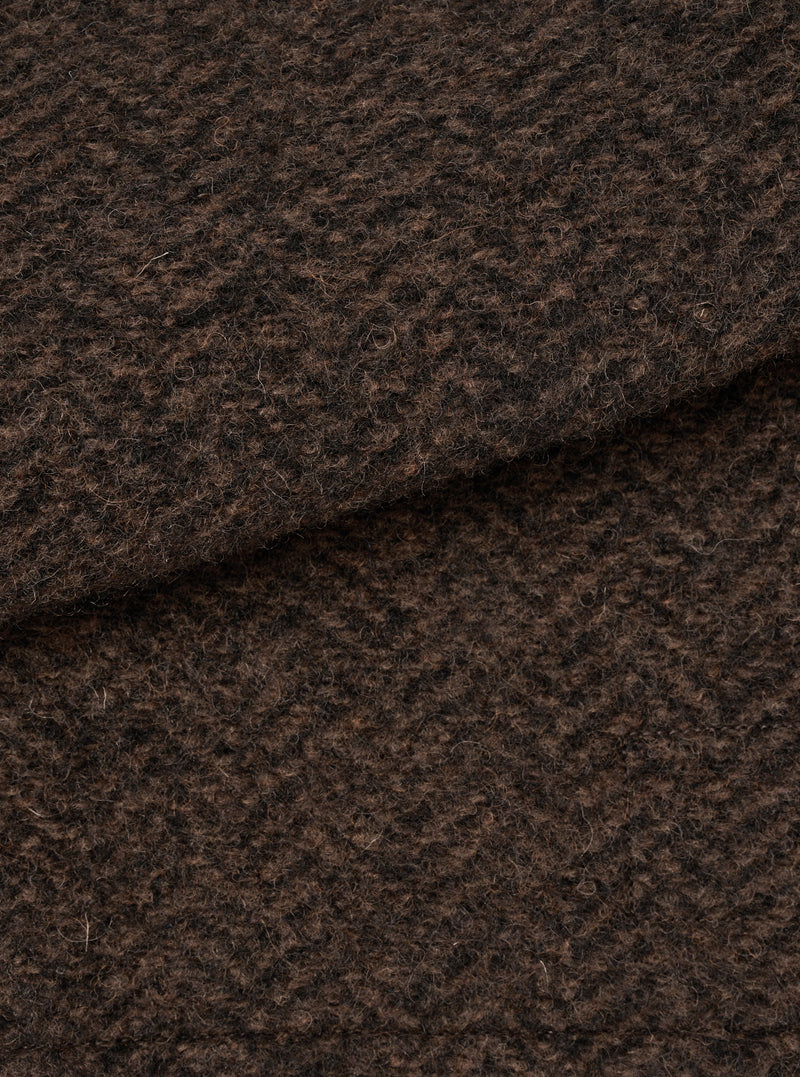 A close-up swatch image showing the textured brown marl wool fleece fabric of the Brown Raven Fleece Rams Jacket on a plain white background, highlighting the dense knit and warm marled color.
