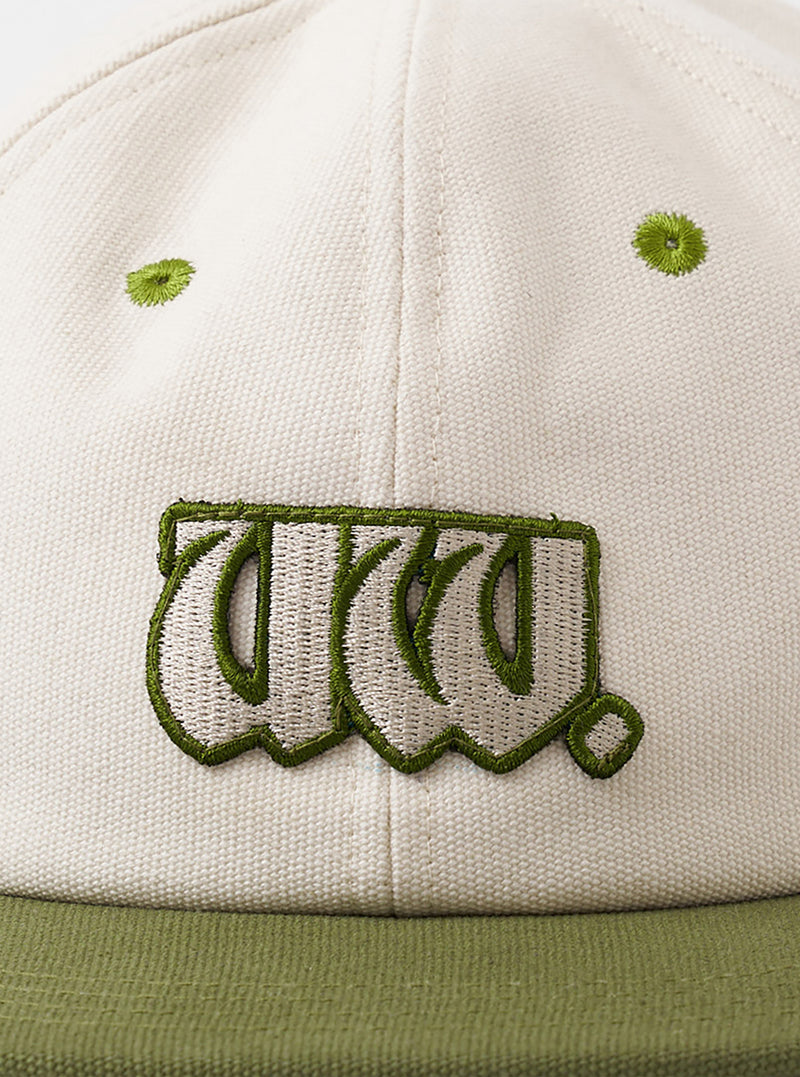 A back view image of the Ecru/Olive Canvas Baseball Hat on a neutral white background. The key focus is the adjustable brown leather strap with a metal clasp and embroidered branding near the rear panel.