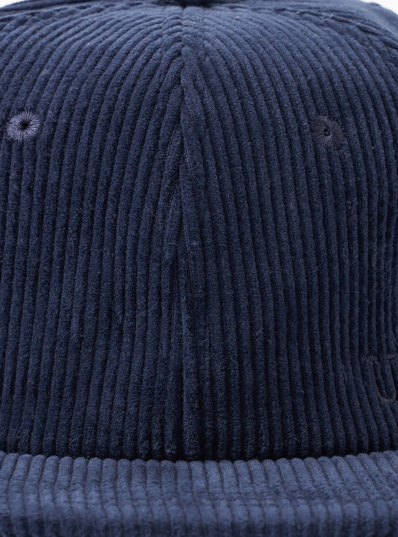 A back view image of the Dark Navy Cord Baseball Hat set against a white background. The shot highlights the adjustable rear strap with a metal clasp and neat paneling across the dark navy corduroy.