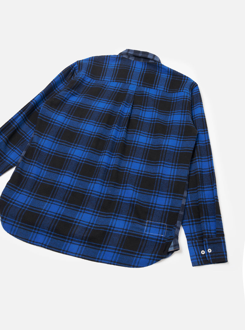 The Navy/Blue Brush Panel Check 1 Lazy Day Shirt is laid flat on a light grey backdrop showing the back. Features a bold blue and black tartan check pattern on brushed flannel fabric, a centre back pleat, and curved hem.