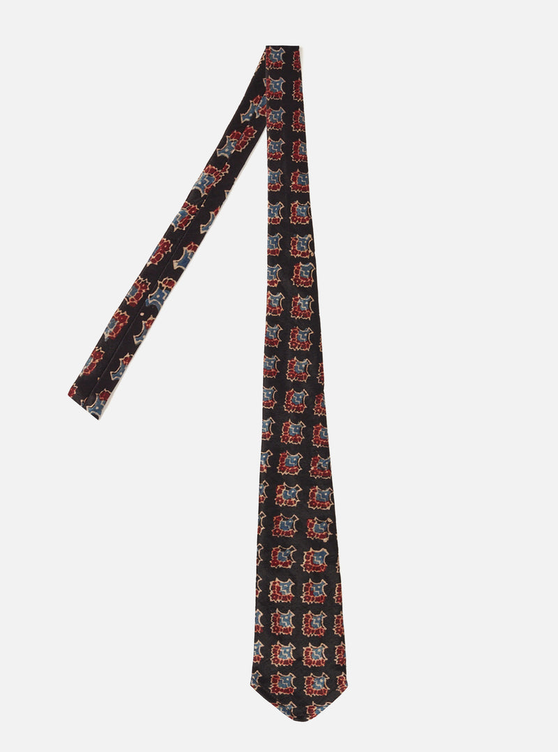 Front product image of the Black Mini Kalamkari Print Tie displayed flat on a clean white background, highlighting the fine printed pattern and smooth polyester viscose fabric construction.