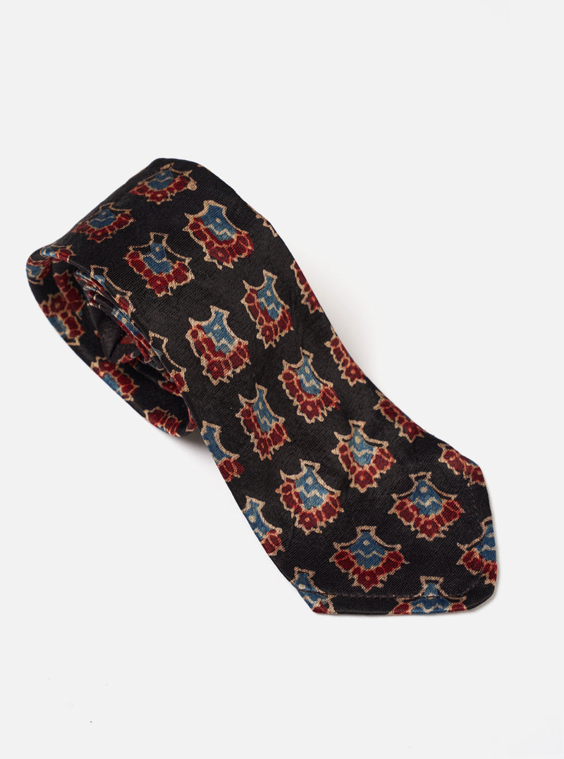 Detailed close-up view of the Black Mini Kalamkari Print Tie against a plain studio background, showcasing the intricate Kalamkari print design, blade width, and subtle fabric texture.
