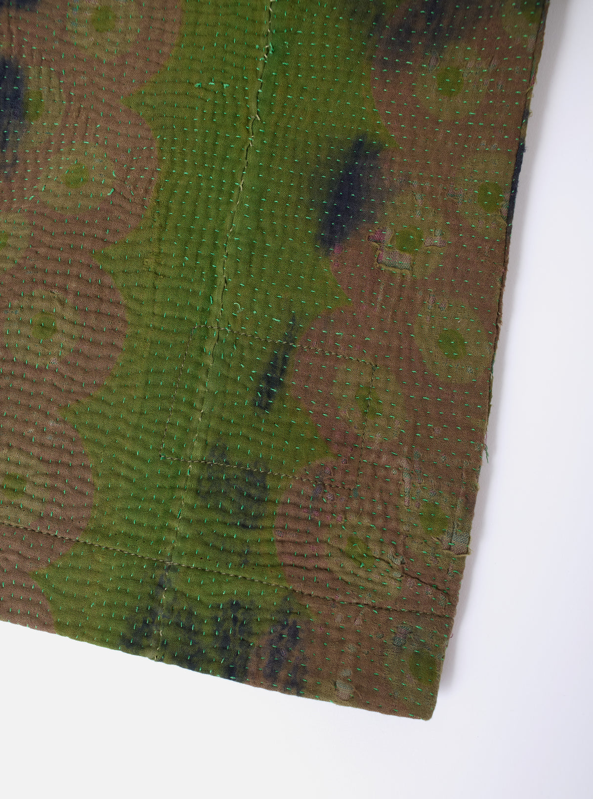 Close-up of the Green Tie Dye #4 Kantha Kyoto Work Jacket - Large, showcasing the tie-dye pattern and kantha stitching on a white background.