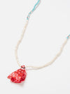 Hanami of Rome Bandana Necklace/Bracelet No.40 on a white surface. Features white, turquoise, and silver beads with a red bandana fabric tassel.  