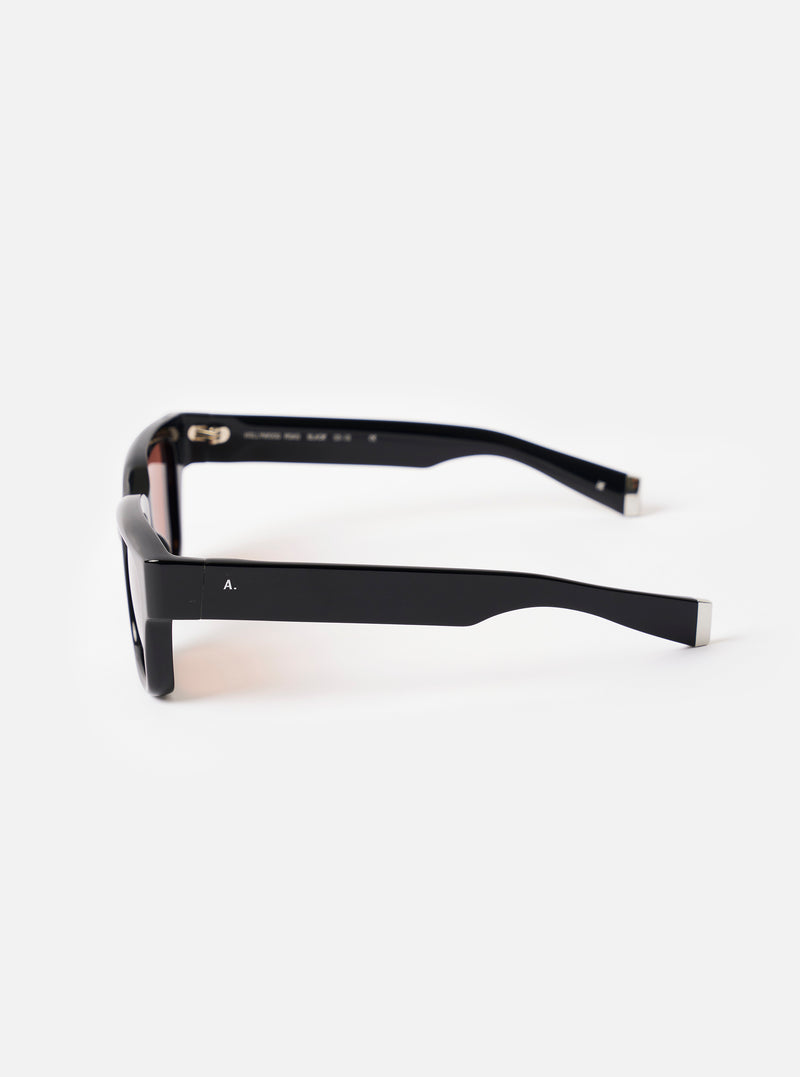 Close-up detailed shot of the inner frame and arm of the A. SOCIETY x Universal Works Black Hollywood Sunglasses on a neutral background, emphasizing the fine branding and construction.