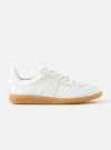 The Novesta for Universal Works Off-White/White Leather German Army Trainer on a white background. The shoe is white leather with a gum sole and white laces.