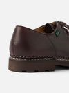 Close-up of the heel and quarter of a Paraboot Michael Marche II in cafe brown leather. Smooth, polished leather upper with a green Paraboot branded tongue tag visible. Distinctive Norwegian welt stitching runs along the midsole join. Chunky dark brown rubber sole with a lugged profile. Plain light grey studio backdrop.