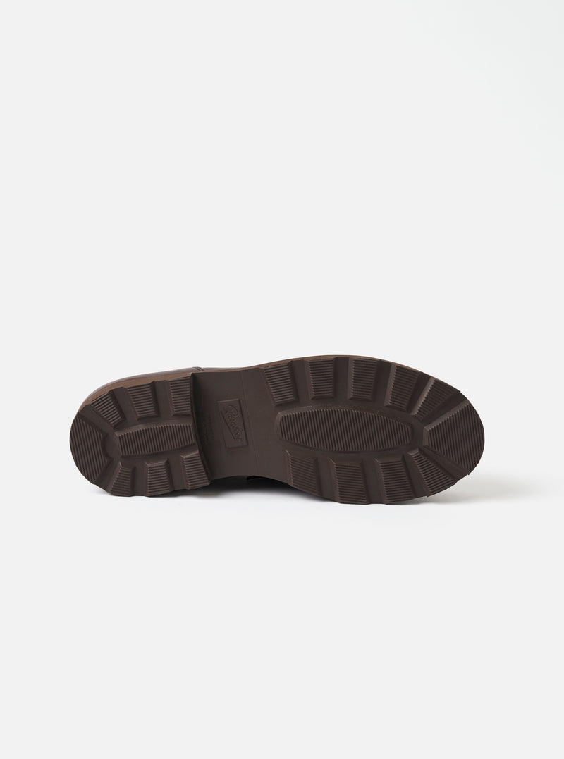 The underside of the Paraboot Cafe Leather Michael Marche II is shown on a plain white studio backdrop. Features a dark brown chunky rubber lug outsole with deep ribbed tread blocks across the forefoot and heel, and an embossed logo.