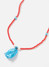Close-up of the Hanami of Rome Bandana Necklace/Bracelet No.8 on a white surface. Features red beads, turquoise accents, and a blue bandana fabric tassel.