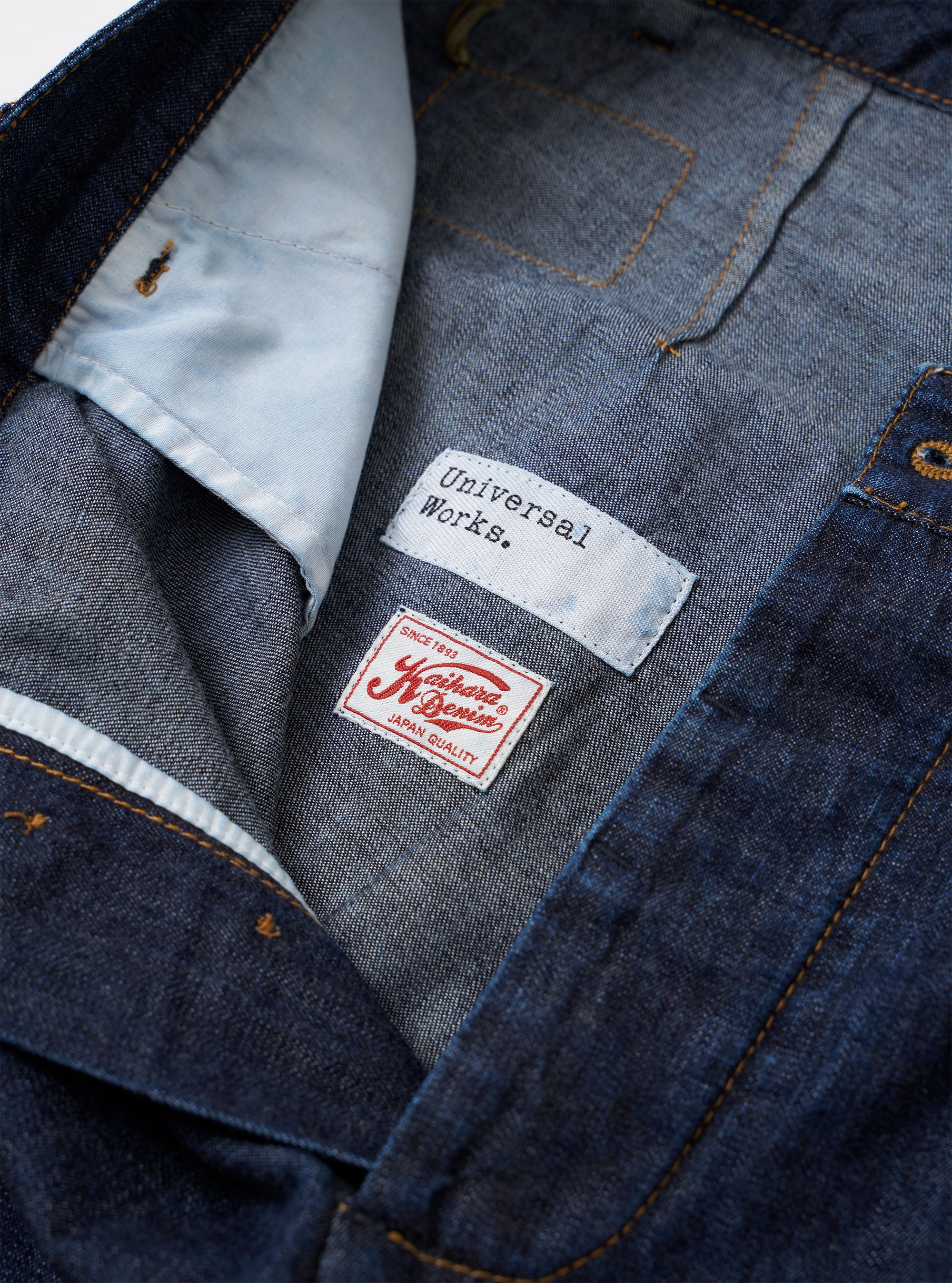 The Indigo Kaihara LT WT Denim Duke Pant is shown as a flat lay against a plain white background. The trousers feature a wide-leg, loose fit with distinct pleats at the waist and a classic button fly. The dark indigo lightweight denim fabric has a visible weave and clean finish.