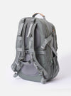 The F/CE.® Foliage Green Recycled Nylon 420 re/cor Travel Backpack is shown from the back as a flat lay against a plain white background. The image highlights the ergonomic, padded shoulder straps and the structured, neoprene-padded back panel. The backpack is made from a technical foliage green recycled nylon fabric with a subtle sheen and features tonal webbing and plastic hardware.