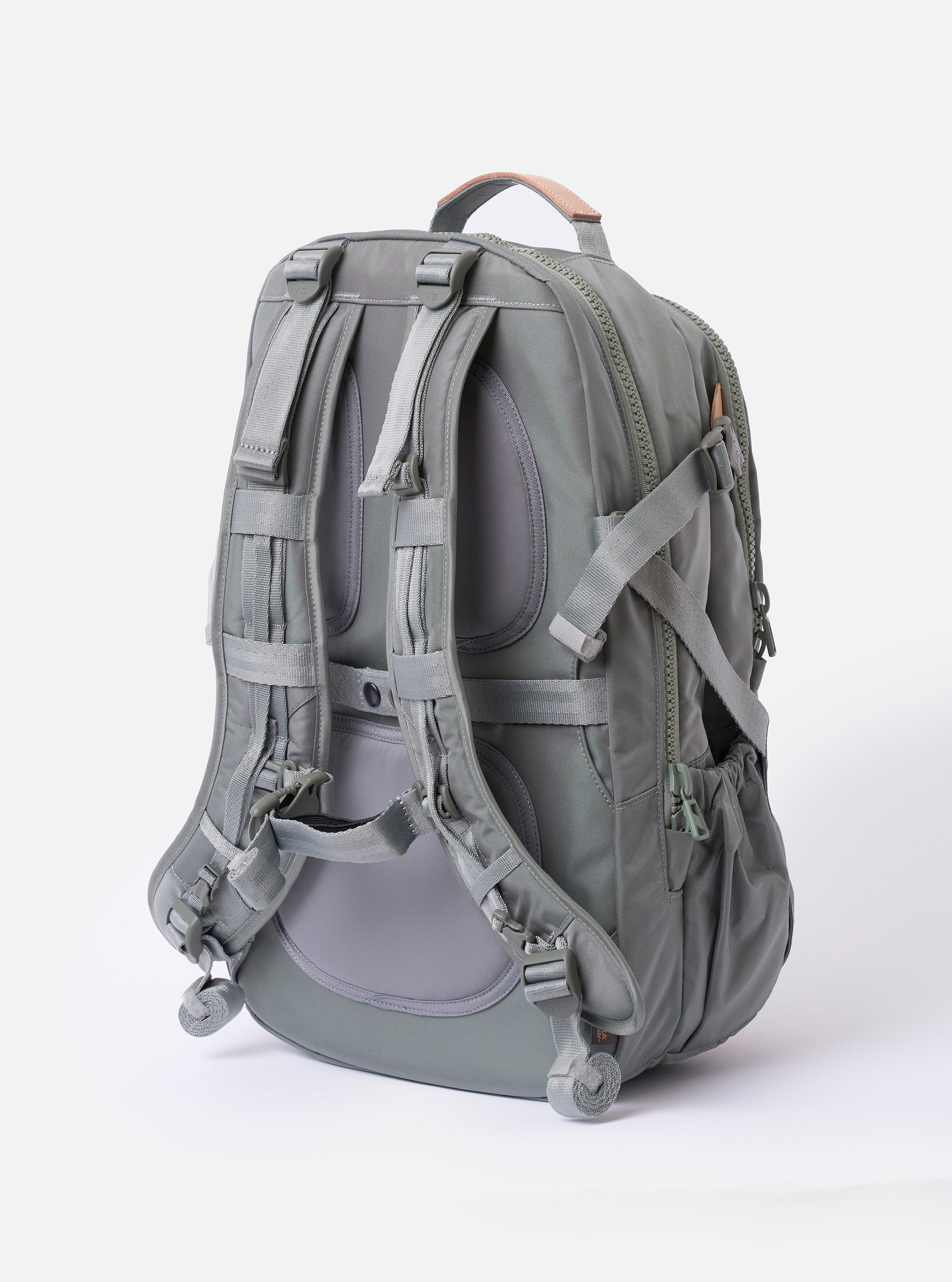 The F/CE.® Foliage Green Recycled Nylon 420 re/cor Travel Backpack is shown from the back as a flat lay against a plain white background. The image highlights the ergonomic, padded shoulder straps and the structured, neoprene-padded back panel. The backpack is made from a technical foliage green recycled nylon fabric with a subtle sheen and features tonal webbing and plastic hardware.
