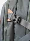The F/CE.® Foliage Green Recycled Nylon 420 re/cor Travel Backpack is shown from a rear angle against a plain white background. The image highlights the padded back panel made of neoprene and the ergonomic shoulder straps, which feature the MOUNTING T SYSTEM for attachments. The foliage green recycled nylon fabric has a subtle sheen, and